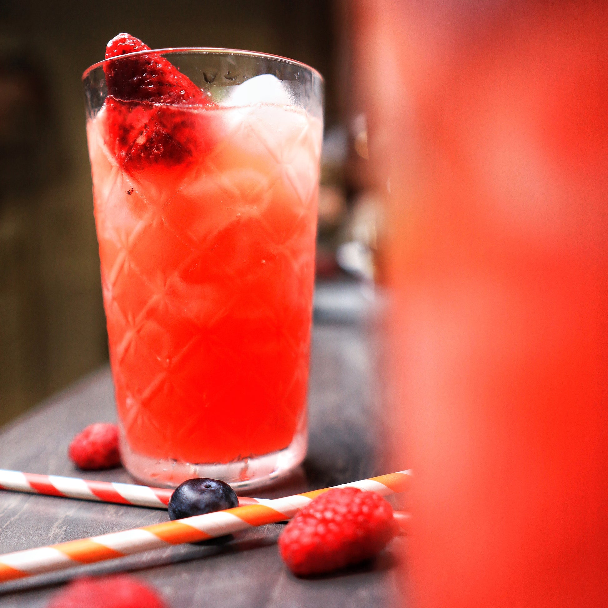 Delicious Special Punch drink from Soft Rockz in glass decorated with Strawberries, Raspberries and Kiwi