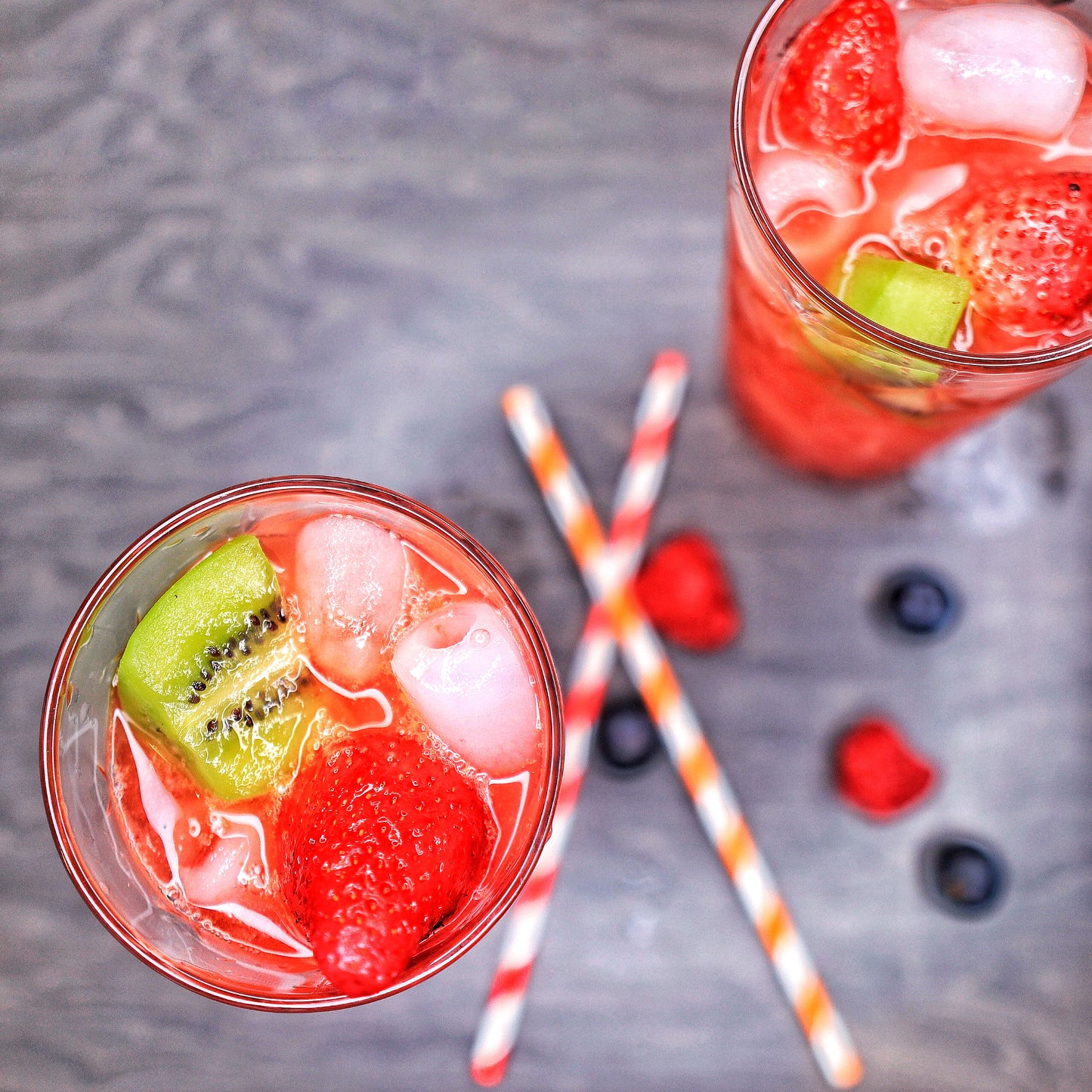 Delicious Special Punch drink from Soft Rockz in glass decorated with Strawberries, Raspberries and Kiwi  