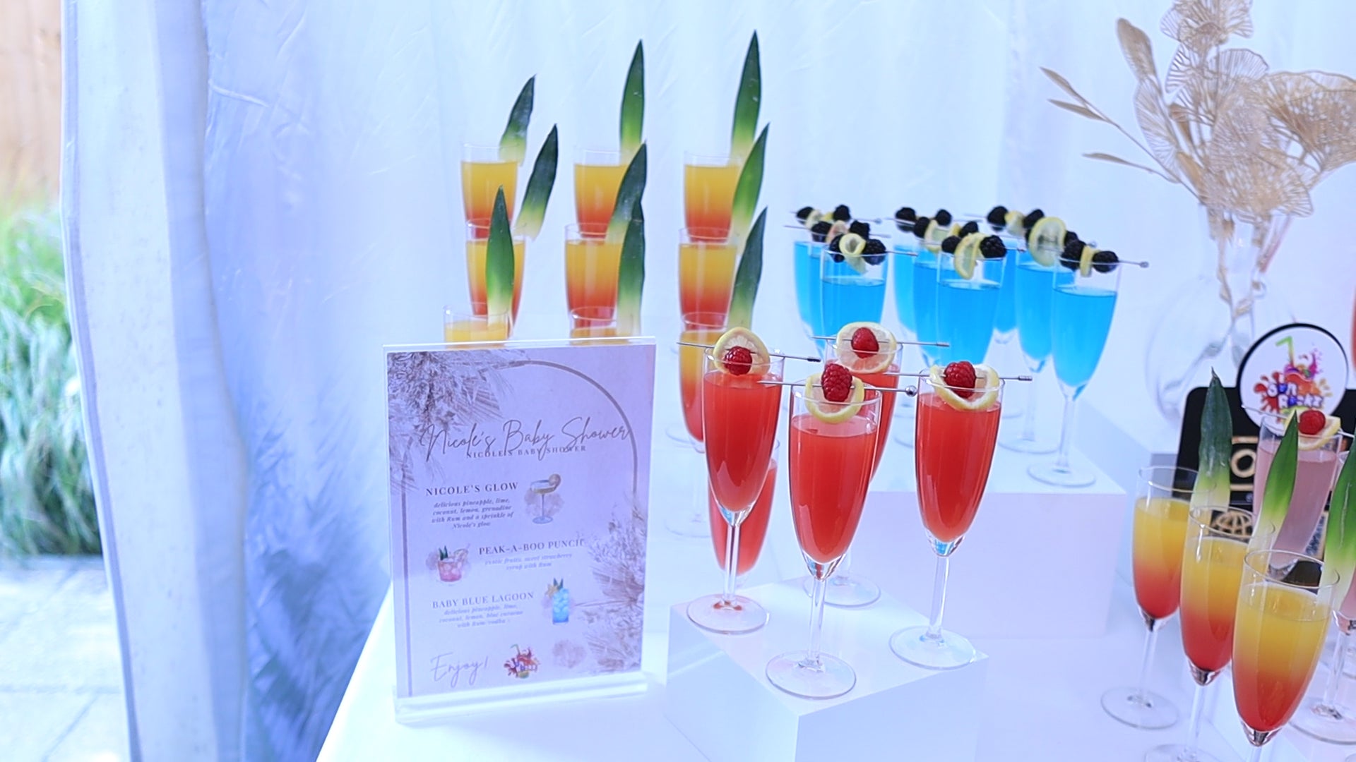 a landscape scan of colourful cocktail/mocktail display for a baby shower