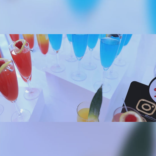 a selection of colourful cocktails and guest helping themselves